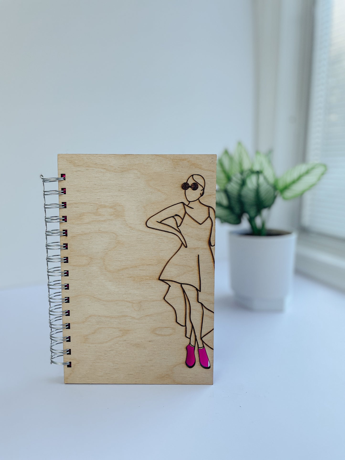 Glamorous woman wearing pink heels wooden journal