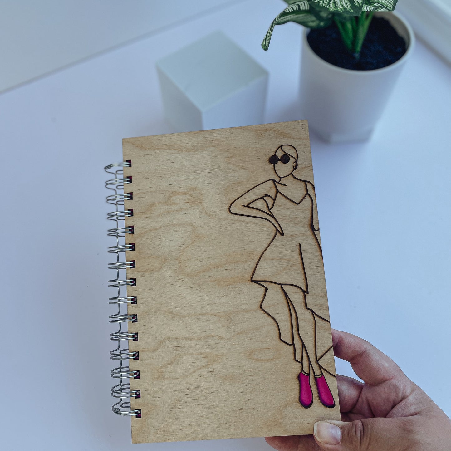 Glamorous woman wearing pink heels wooden journal