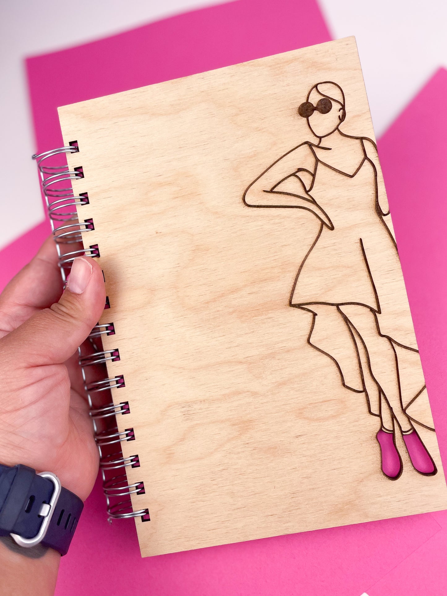Glamorous woman wearing pink heels wooden journal
