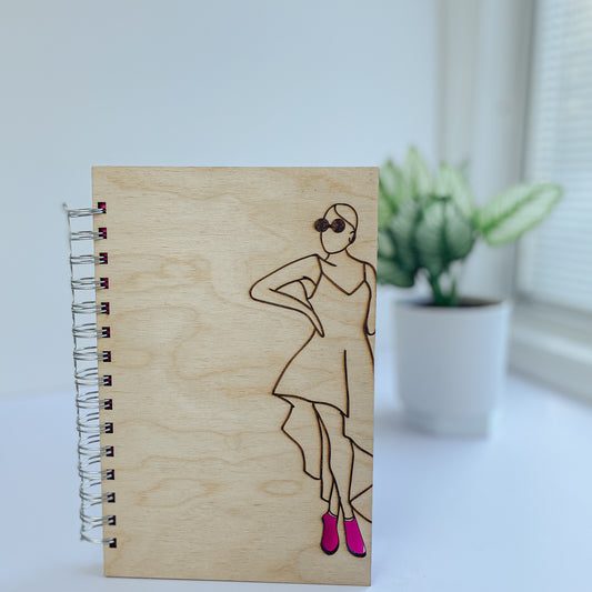 Glamorous woman wearing pink heels wooden notebook