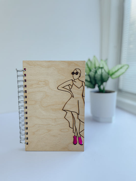 Glamorous woman wearing pink heels wooden notebook