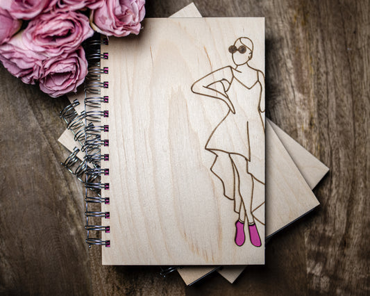 Glamorous woman wearing pink heels wooden journal
